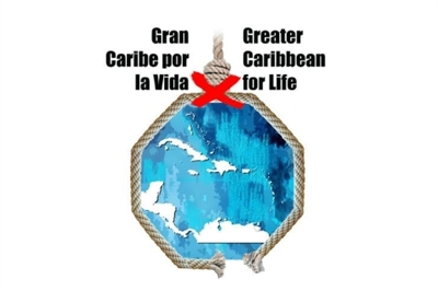 [ai] Graphic depicting the outline of the Caribbean region, enclosed within a rope frame. The text "Gran Caribe por la Vida" and "Greater Caribbean for Life" is displayed, with a red 'X' crossing out the English version.